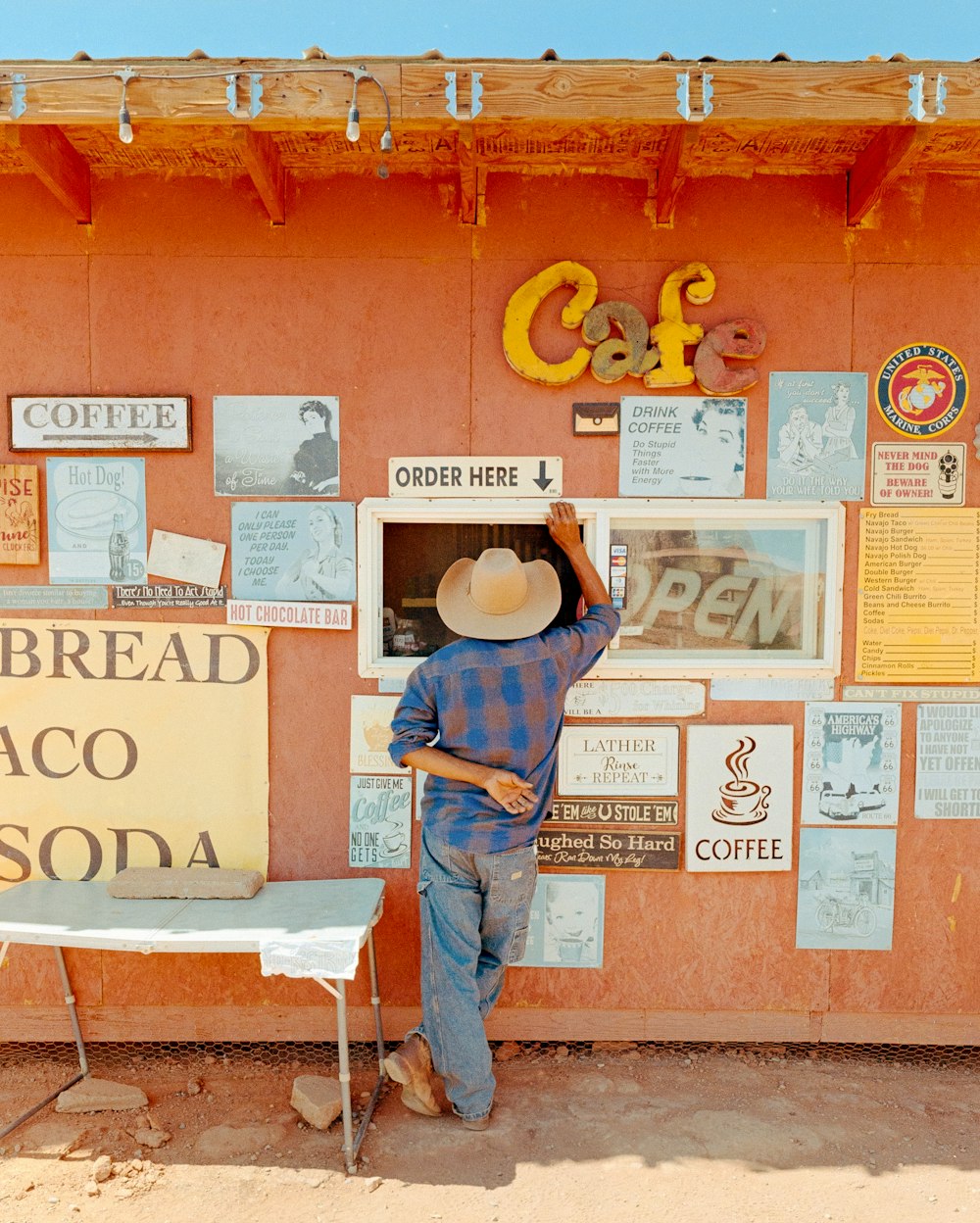 a person standing next to a wall with signs on it