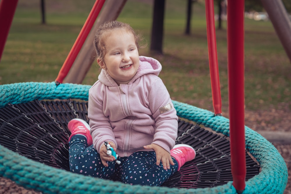 a girl sitting in a swing