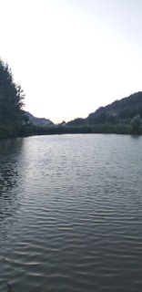 A serene lake at dawn with gentle ripples.