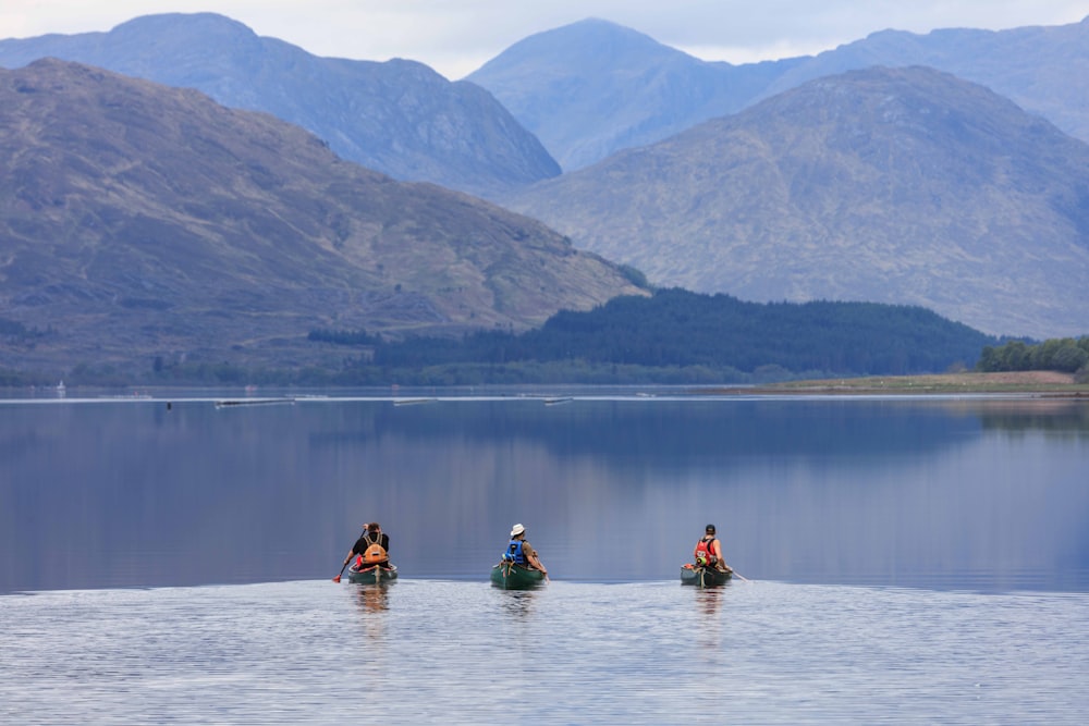 a group of people in small boats on a lake