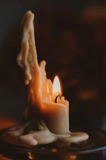 Handcrafted beeswax candles glowing warmly, made from our own beeswax