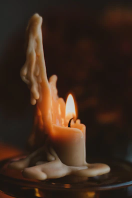 A candle-making setup with melted wax, wicks, and molds ready for crafting new lumiflame candles.