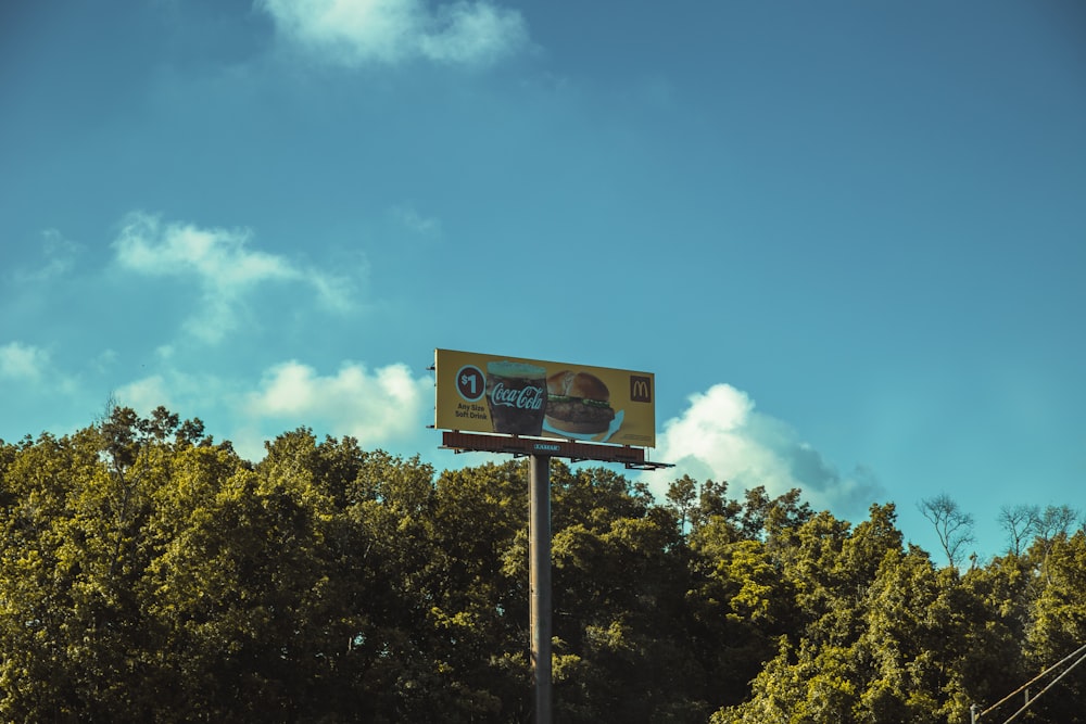 a sign with trees in the background