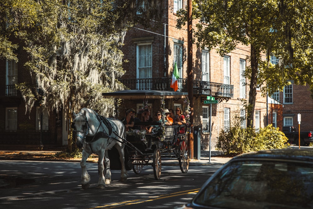 a horse carriage with people in it