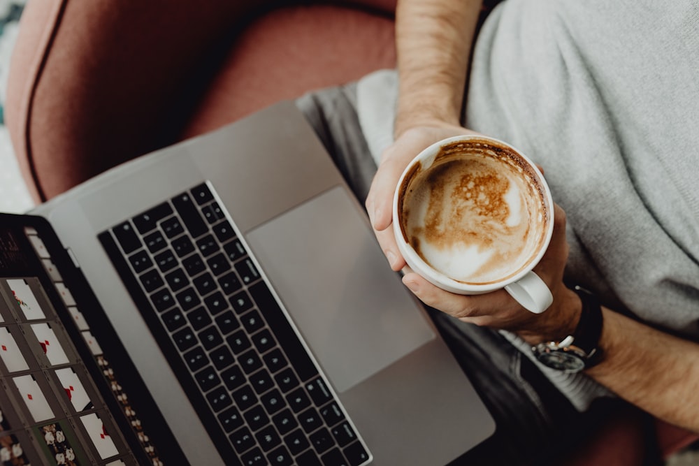 a person holding a cup of coffee