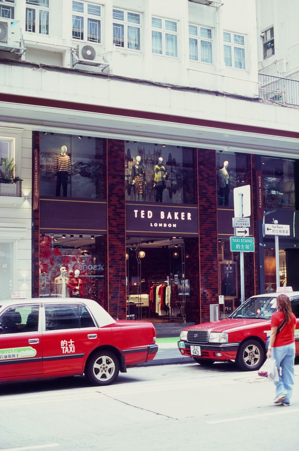 a person walking in front of a storefront