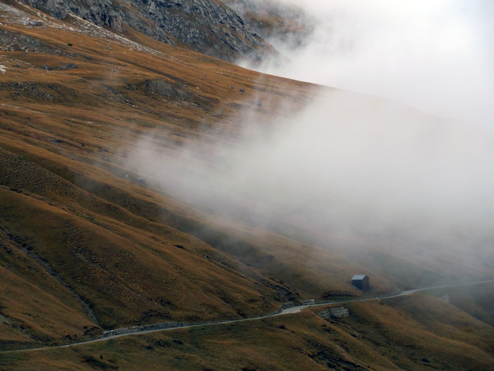 a foggy valley with a road