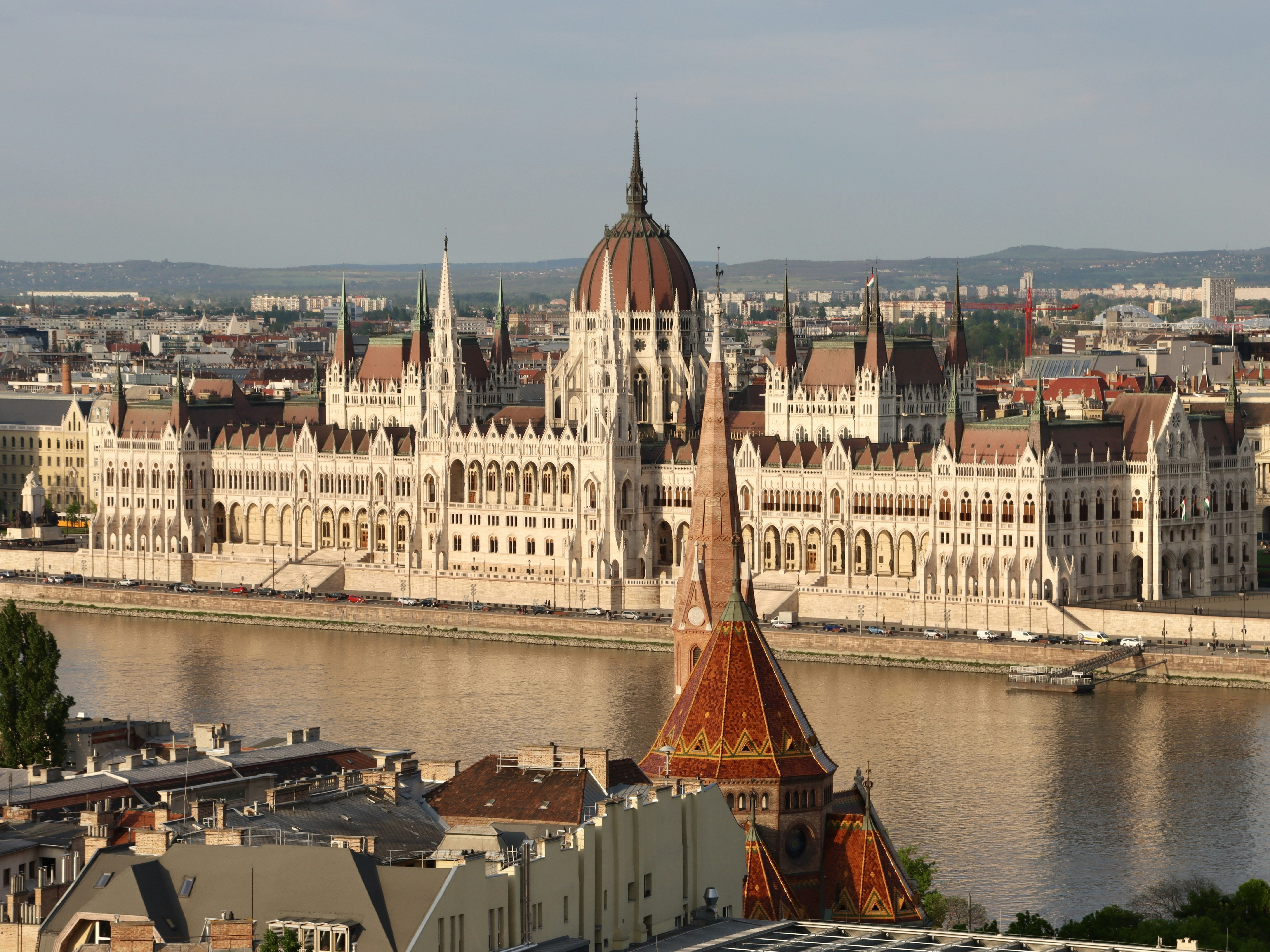 a large building with a domed roof by a body of water
