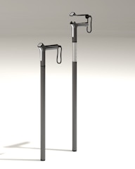 A sleek, modern walking cane with ergonomic handle resting beside a cozy armchair.