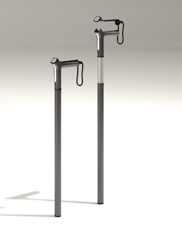 A sleek walking cane with ergonomic handle resting beside a cozy armchair.