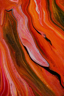 An abstract brushstroke pattern blending bold reds and blacks, evoking creative energy.