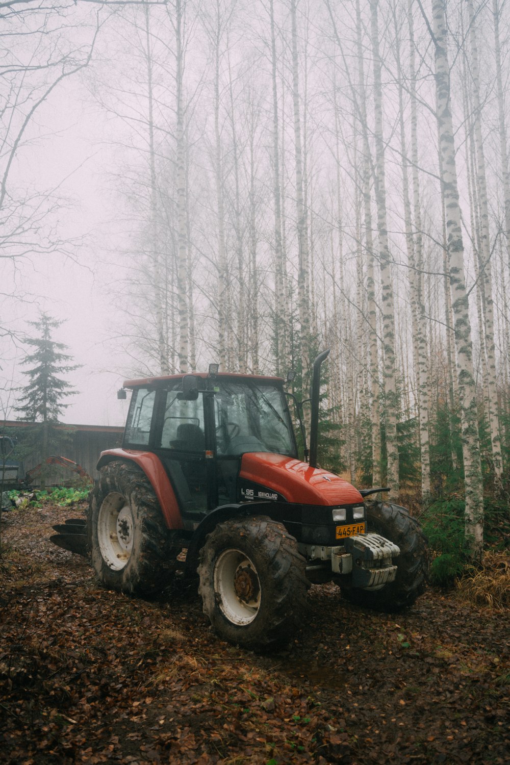 a tractor parked in a wooded area