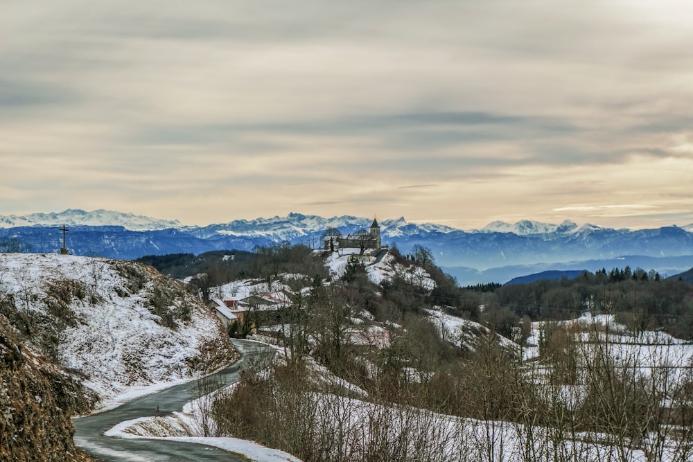 a snowy landscape with trees and mountains