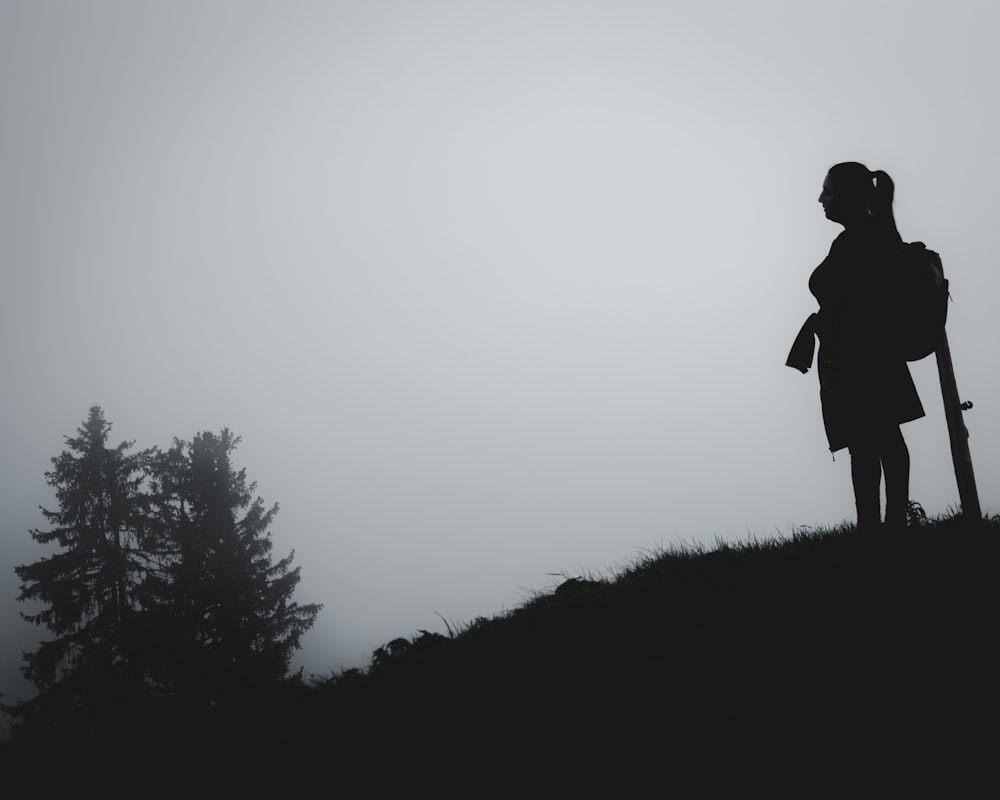 a person with a backpack walking on a hill