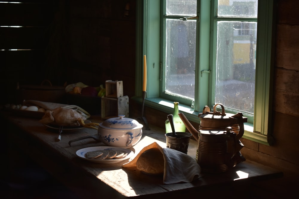 a table with a tea set and teapots on it