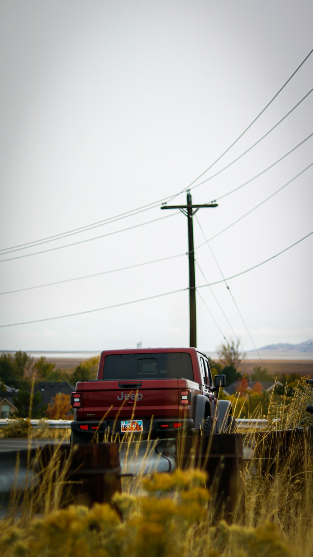 a red truck parked on the side of a road