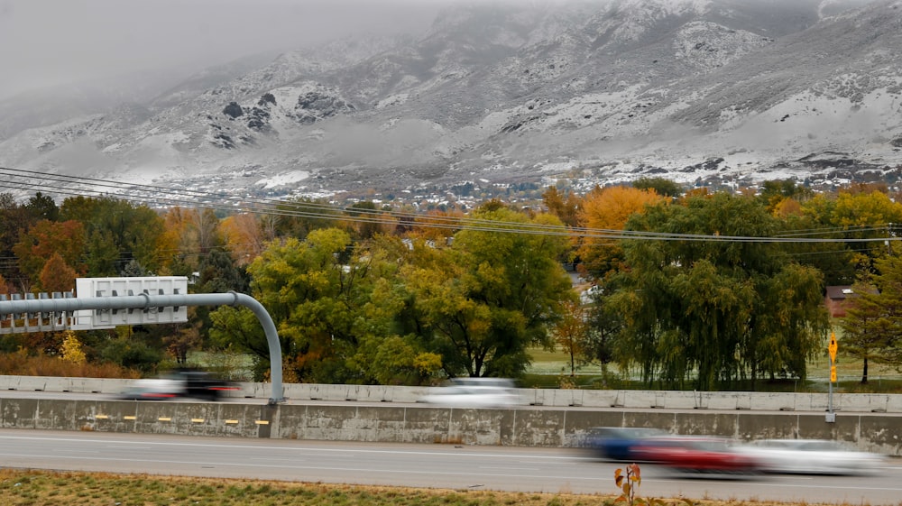 a road with trees and mountains in the background