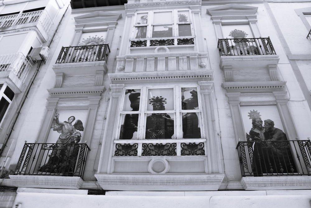 a group of people standing on the balcony of a building