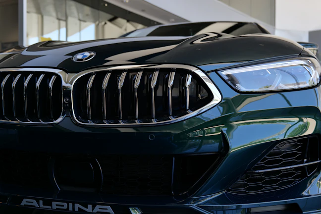 Artistically shot image of a premium SUV’s front grille with éclatauto’s prime ppf applied, sparkling in city lights