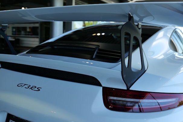 Rear view of the Porsche 911 GT3 with its distinctive spoiler and taillights illuminated.