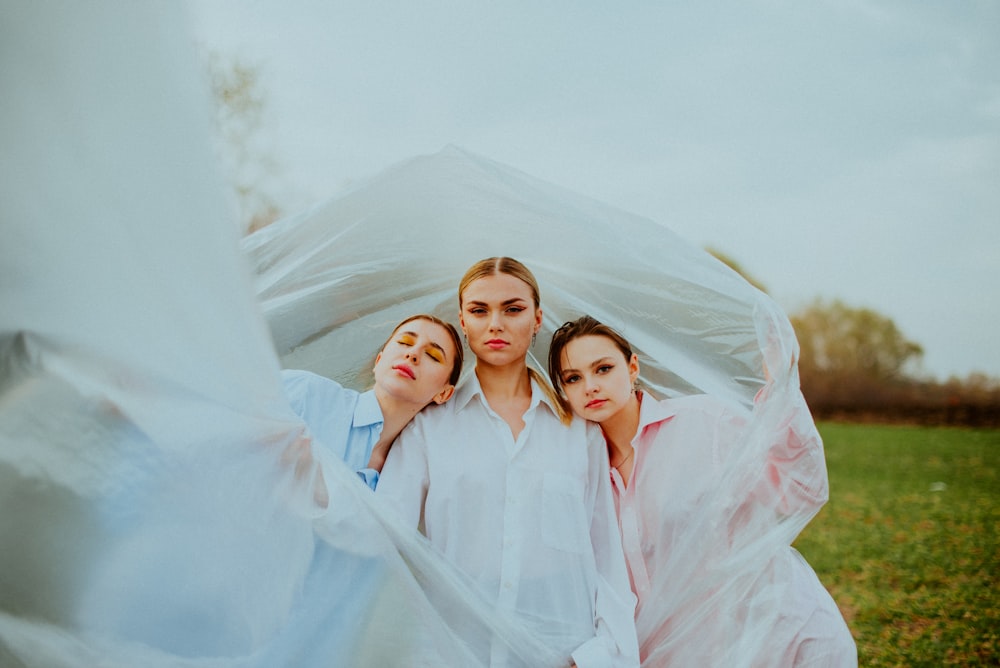 a group of women in white dresses