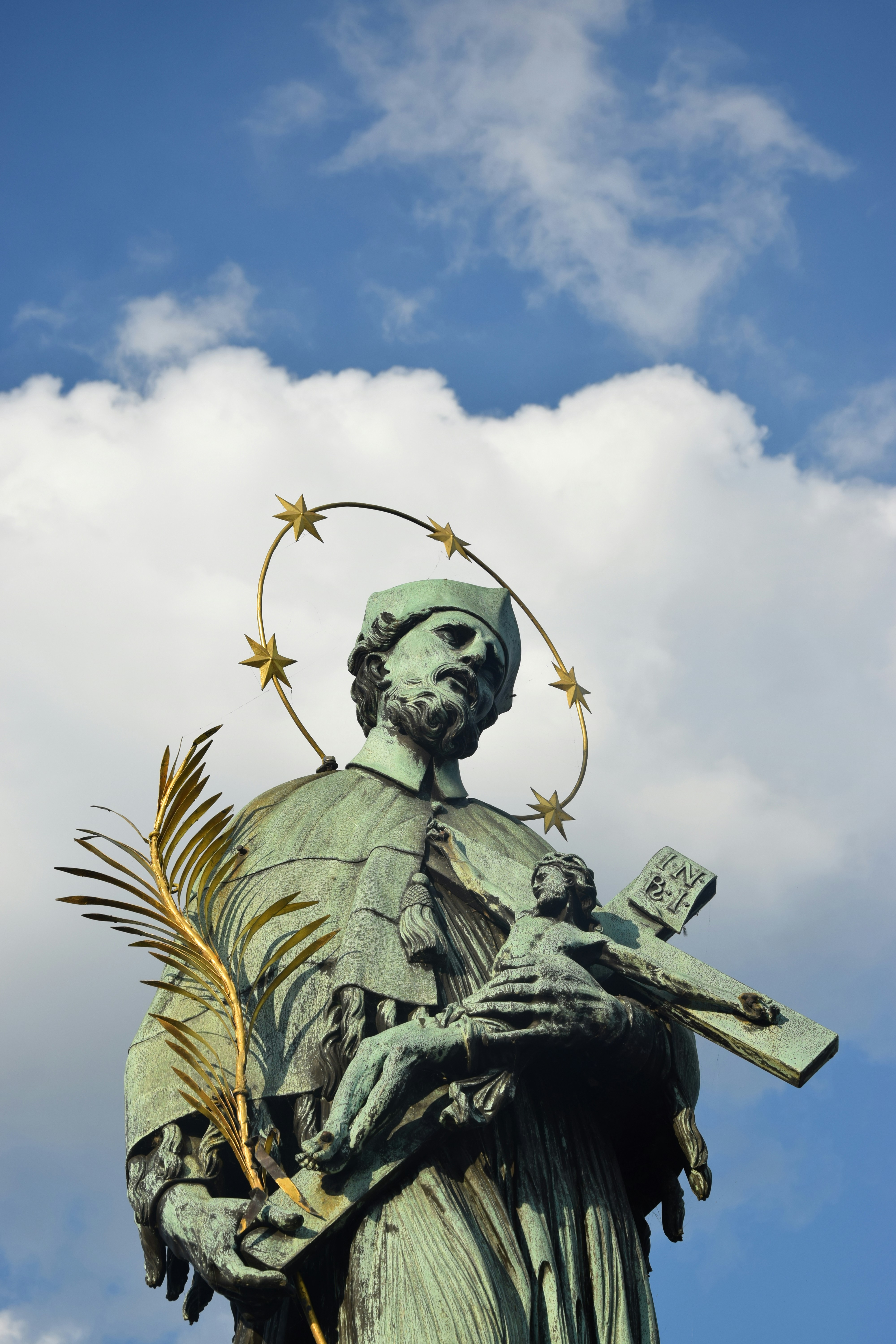 a statue of a person holding a book and a crown