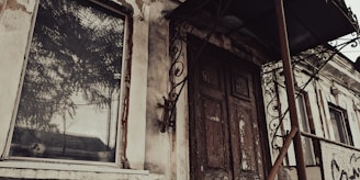 The eerie glow of a ruined building’s fire reflecting off a rusty metal door.
