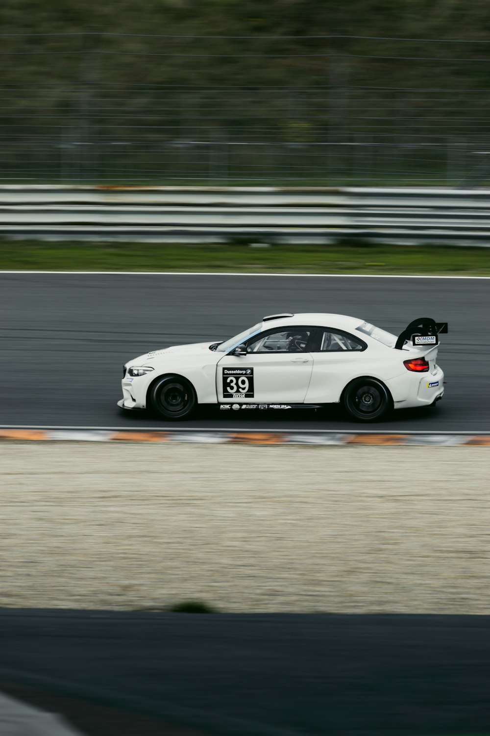 a white race car on a track