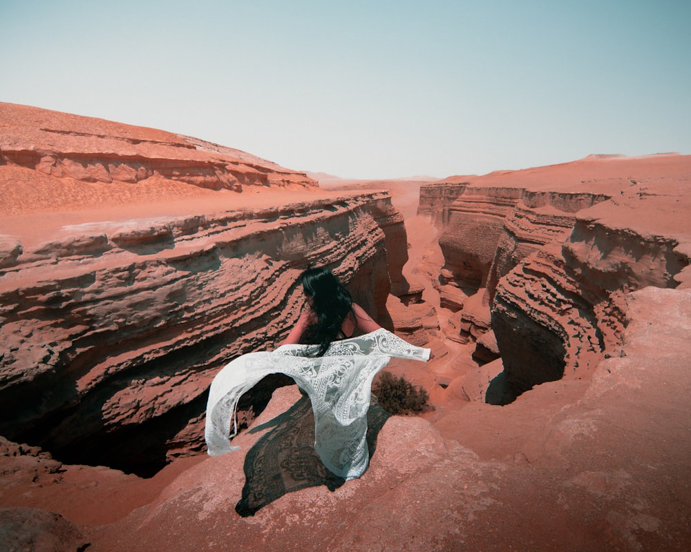 a person lying on a rock