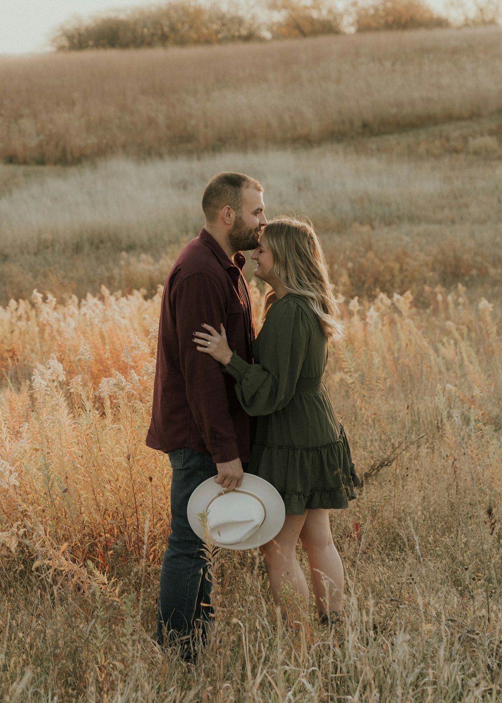 a man and woman kissing in a field