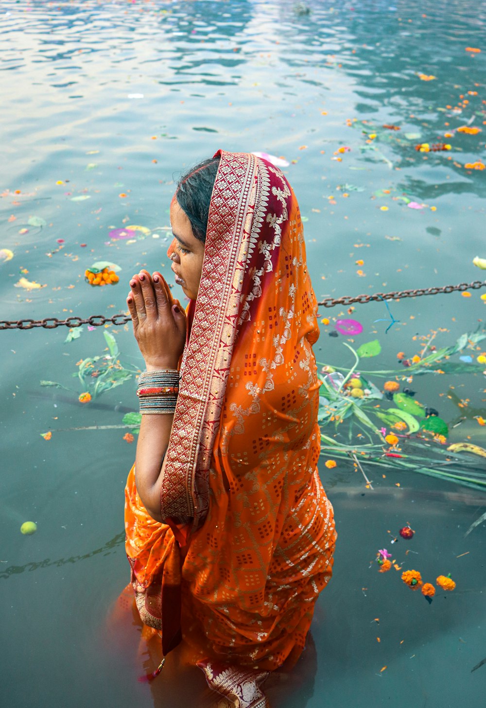 a person in a scarf standing in water