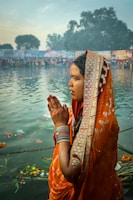 a person wearing a robe and standing in front of a body of water