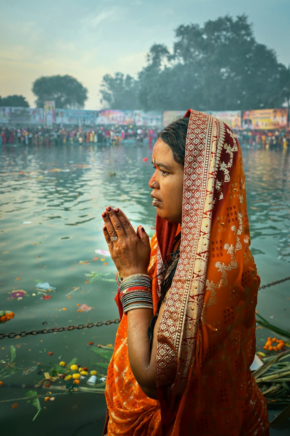 a person wearing a robe and standing in front of a body of water