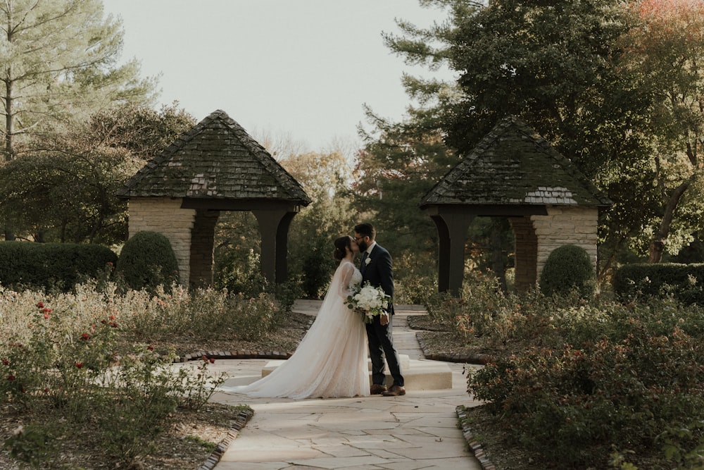 a man and woman kissing outside