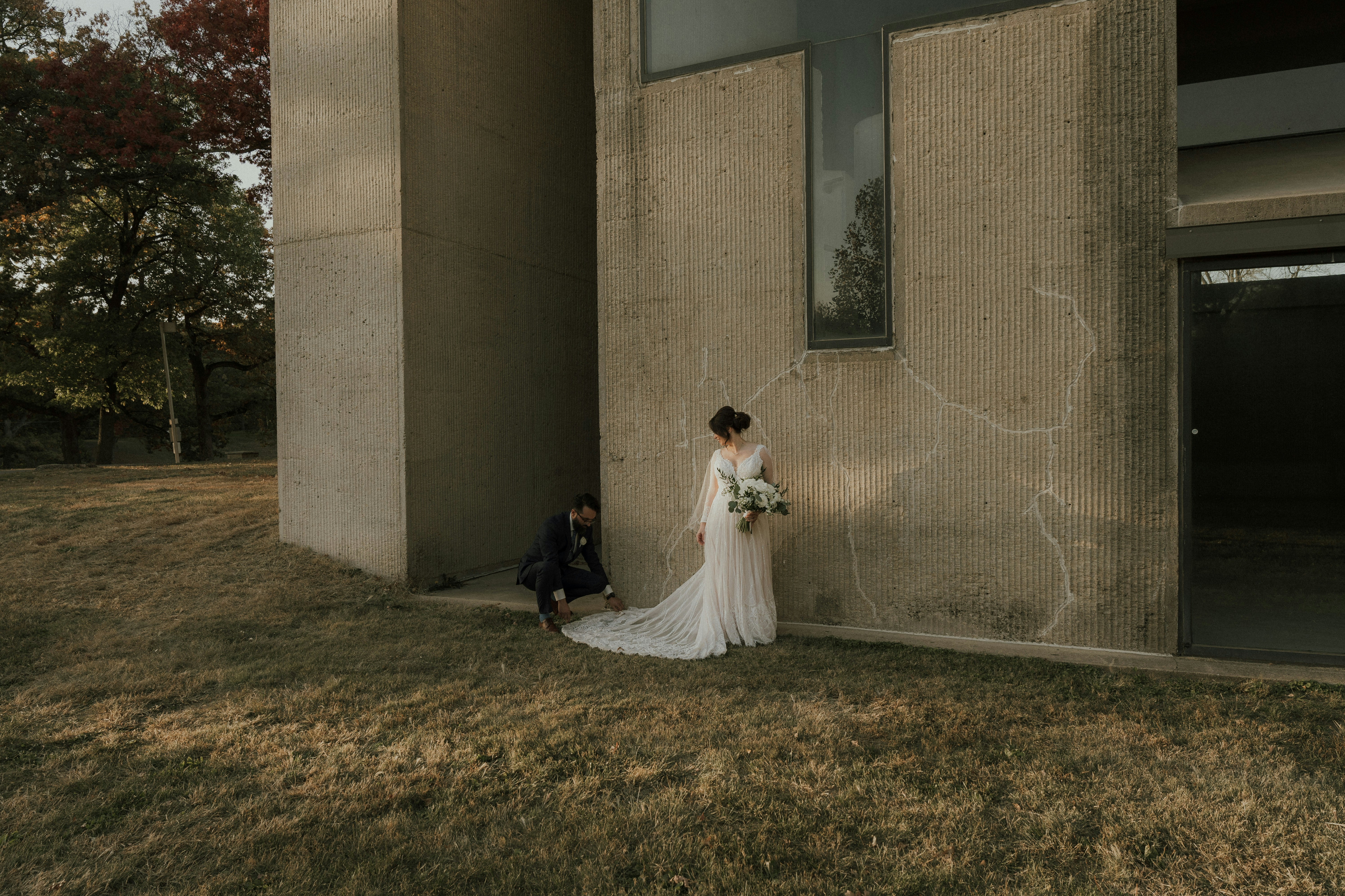 a bride and groom posing for a picture outside a building