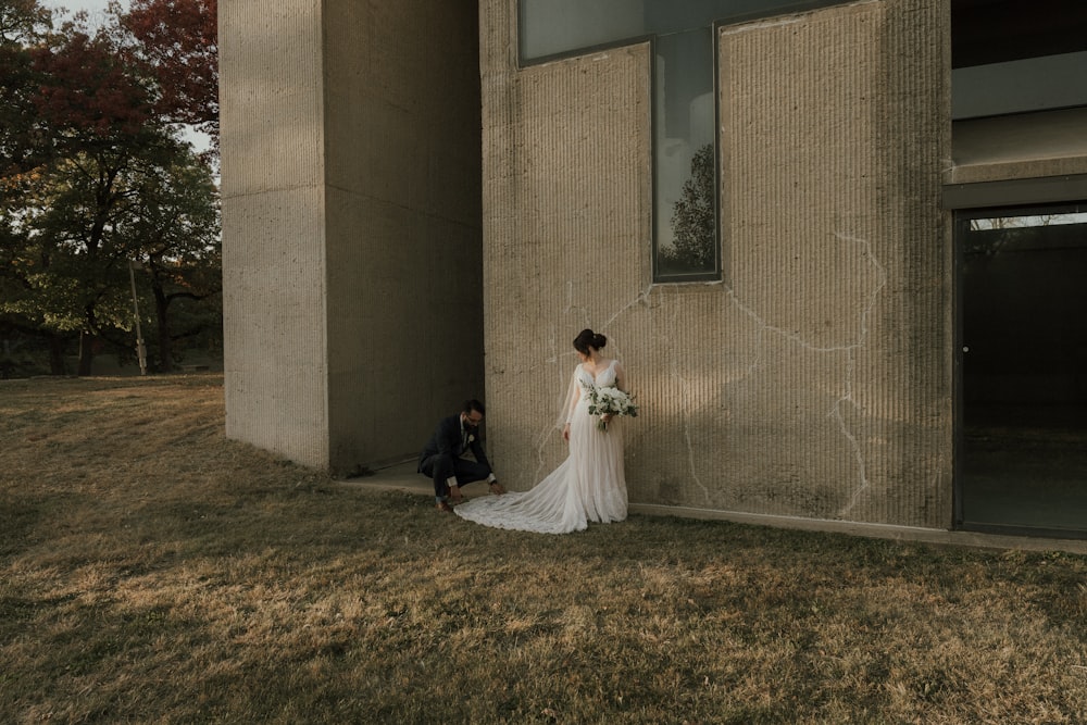 a bride and groom posing for a picture outside a building