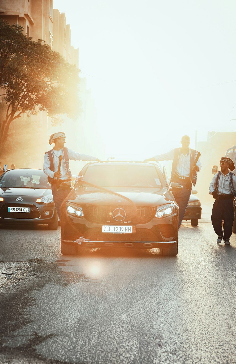 a group of people standing next to a car with a cartoon on it