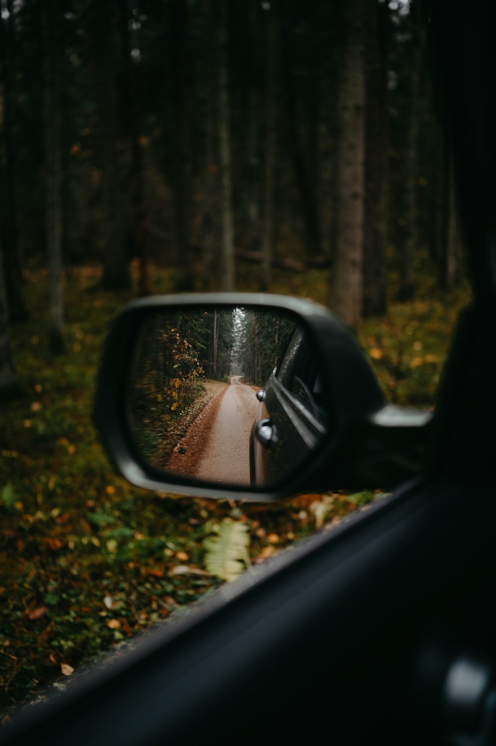 a side view mirror showing a car