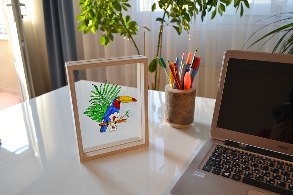 a laptop next to a picture of a bird