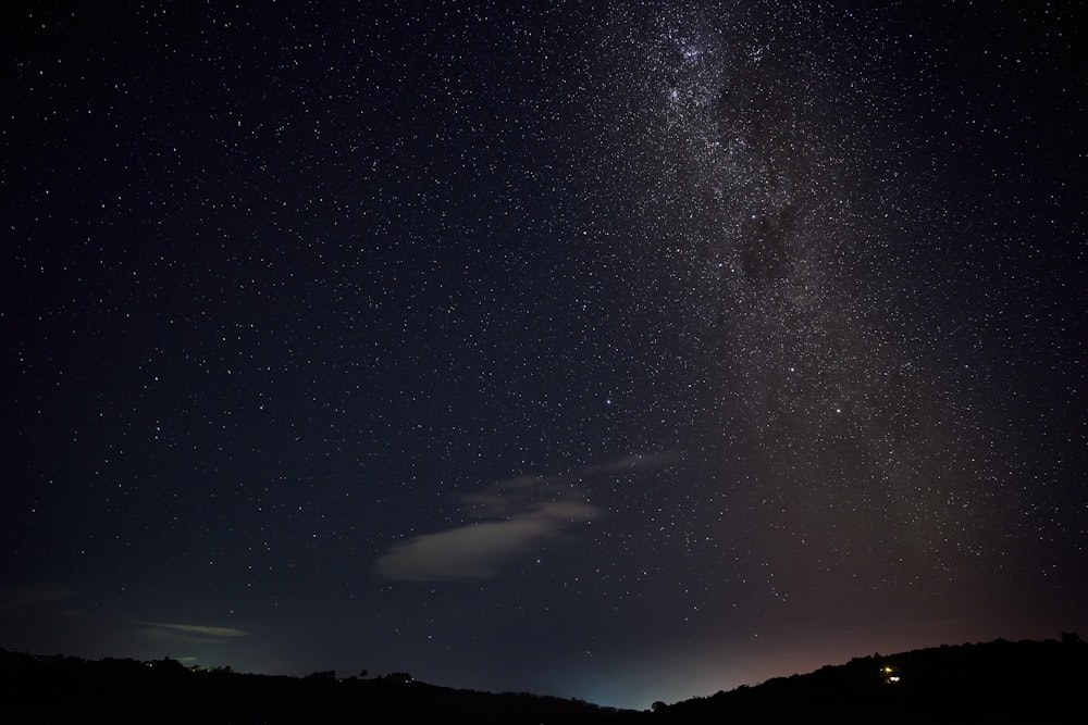 a starry night sky with a crescent moon and a crescent moon