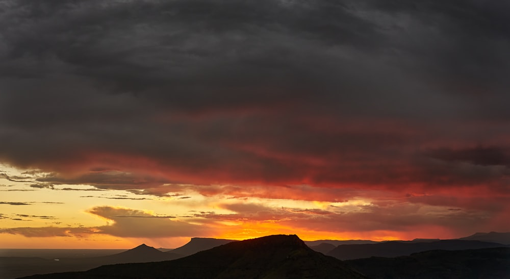 a sunset over mountains