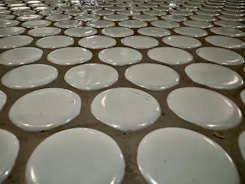 Close-up of hands installing ceramic tiles with precision