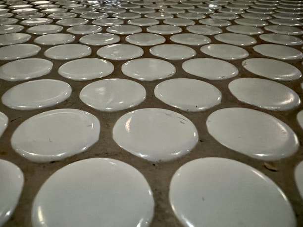 Close-up of creamy tile adhesive being smoothly applied to a floor tile surface.