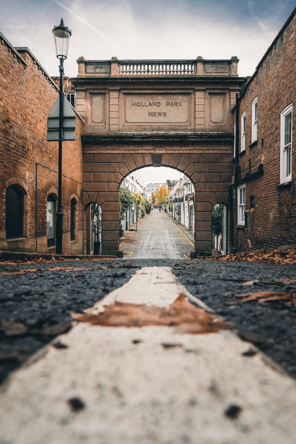 a brick archway with snow on the ground