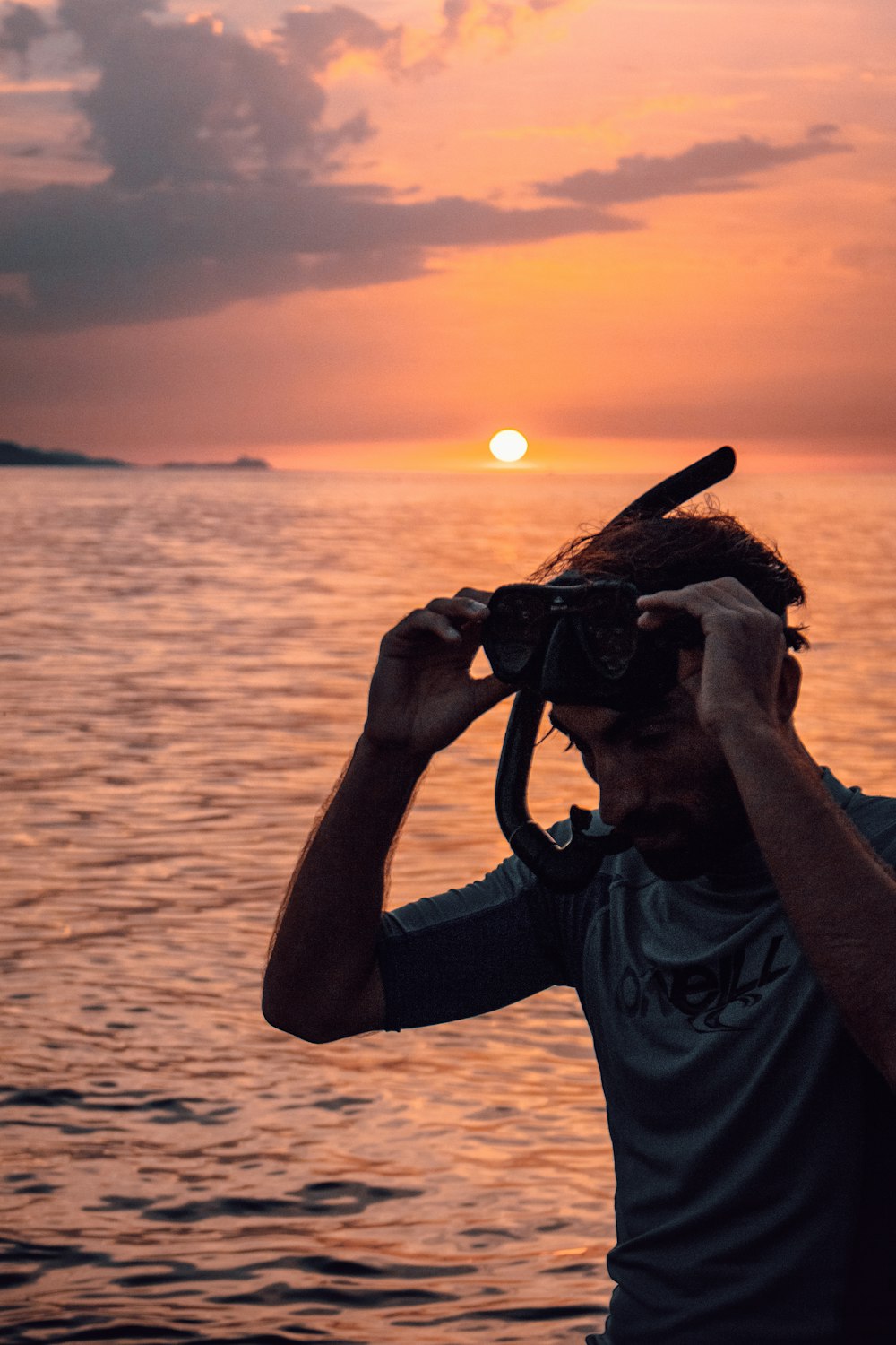a person taking a picture of the sunset