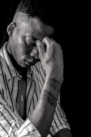 Close-up of a hand applying a colorful anti-stress patch on the wrist, showing before and after calm expressions.