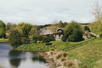 A serene view of the historic Buttery Cottage surrounded by lush greenery.