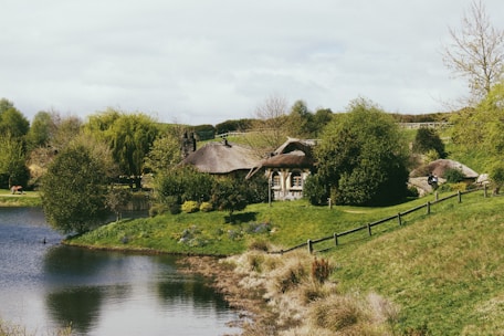 A serene view of the historic Buttery Cottage surrounded by lush greenery.