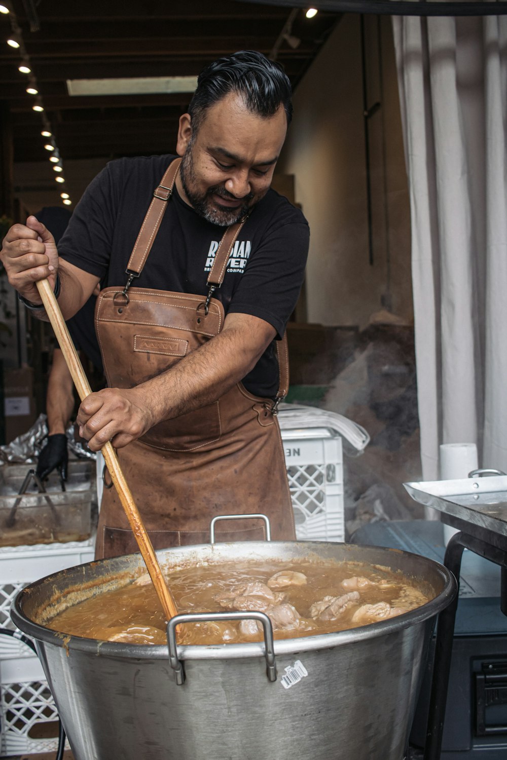 A man cooking food in a large pot photo – Free Food Image on Unsplash