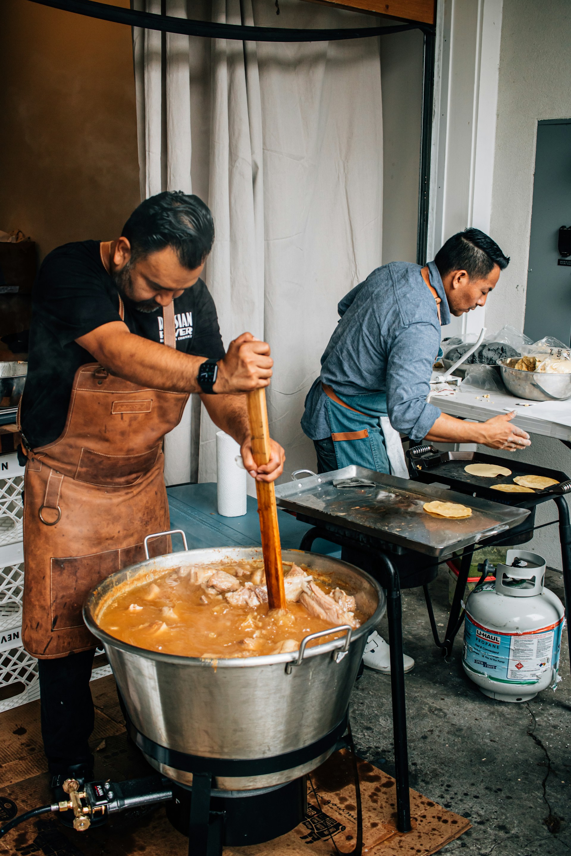 a couple of men cooking